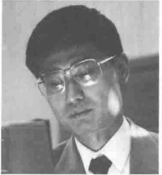 Head and shoulders of a man in glasses