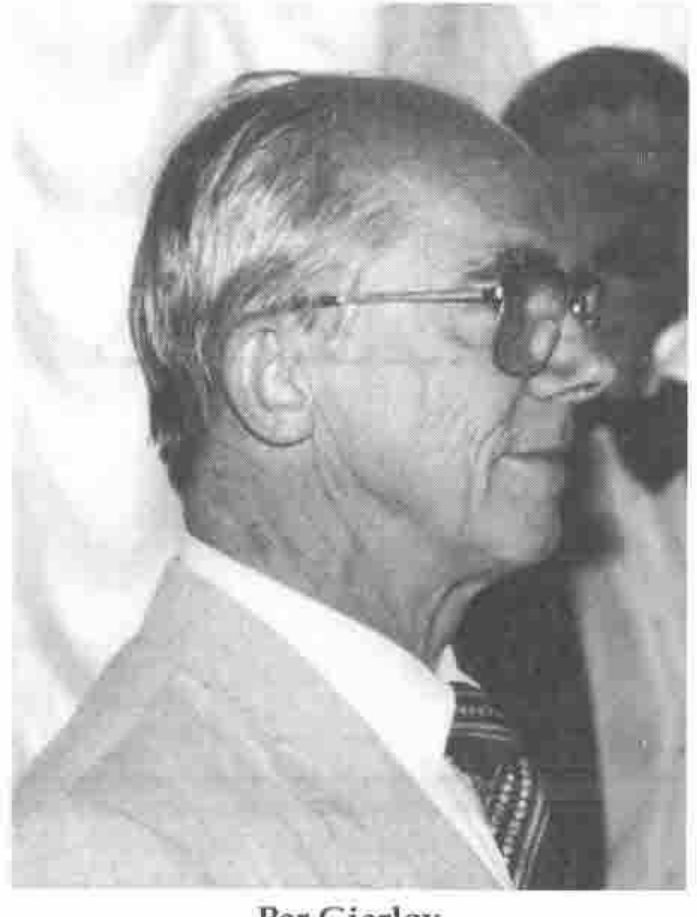 Profile of a grey-haired man in glasses