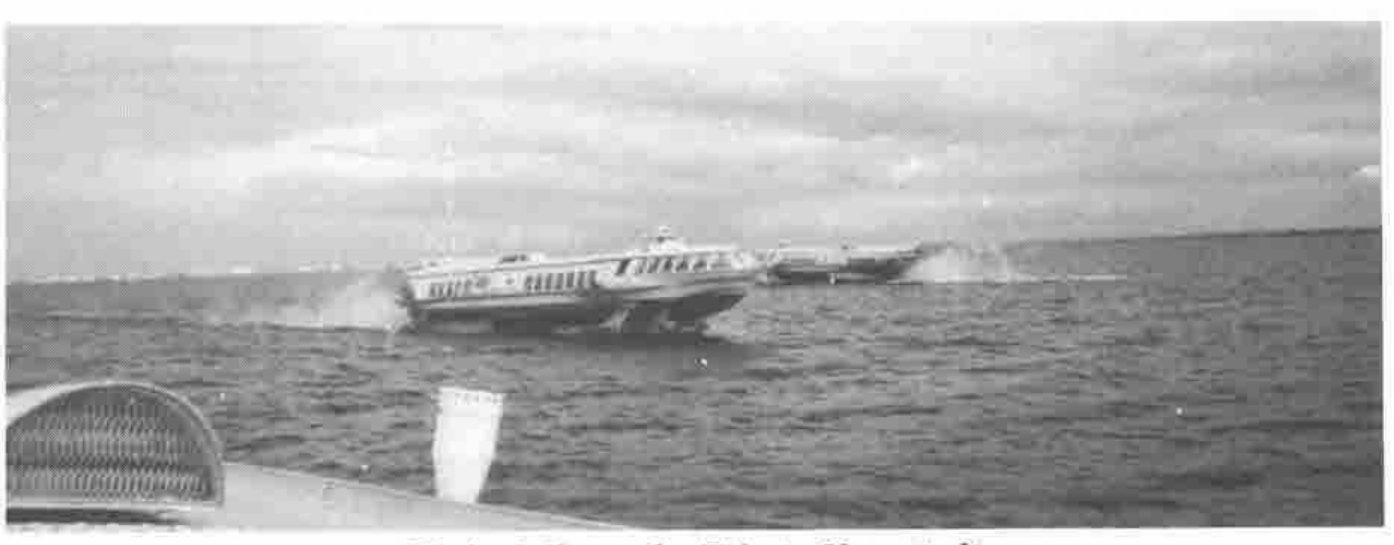 Two hydrofoils skimming across open water