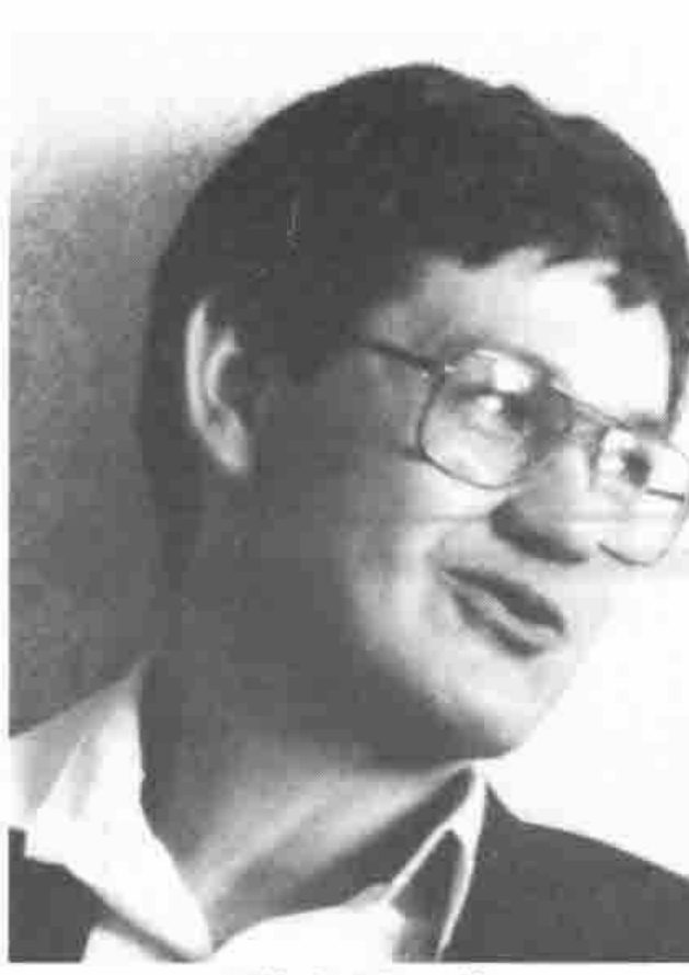 Head and shoulders of a man in glasses