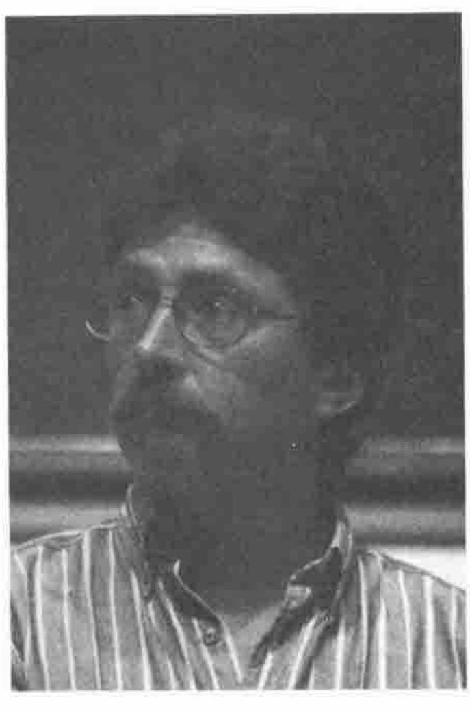 Head and shoulders of Eric Iverson, bearded, in glasses