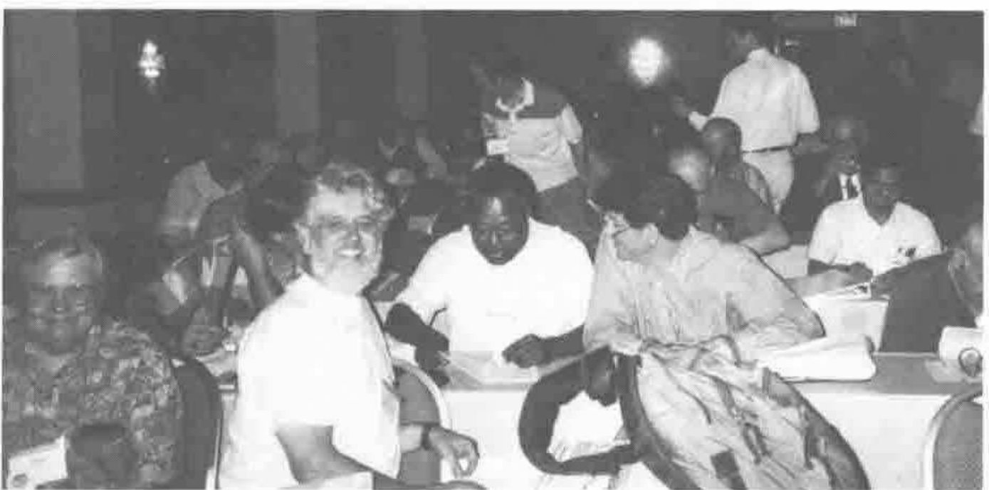 Delegates seated at tables in a conference hall