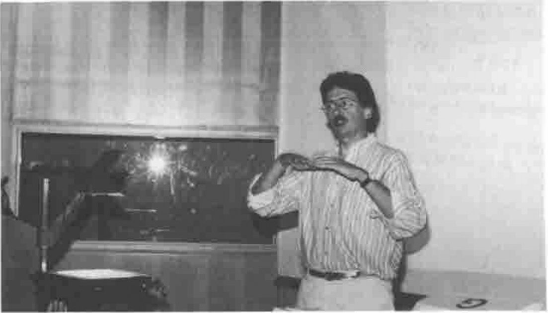 Eric Iverson gesturing in front of a projection screen