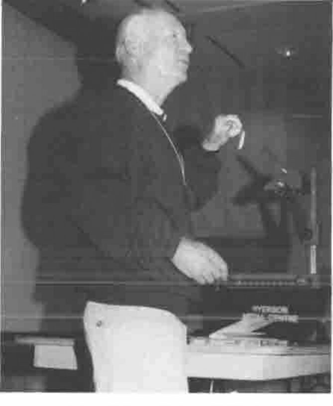 Ian Sharp speaking at a lectern