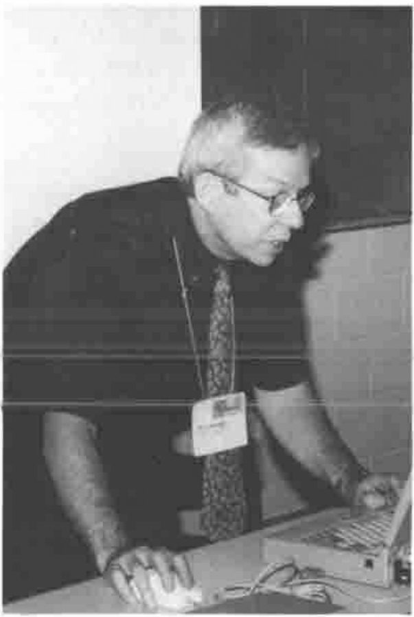 Eric Lescasse leaning over a laptop