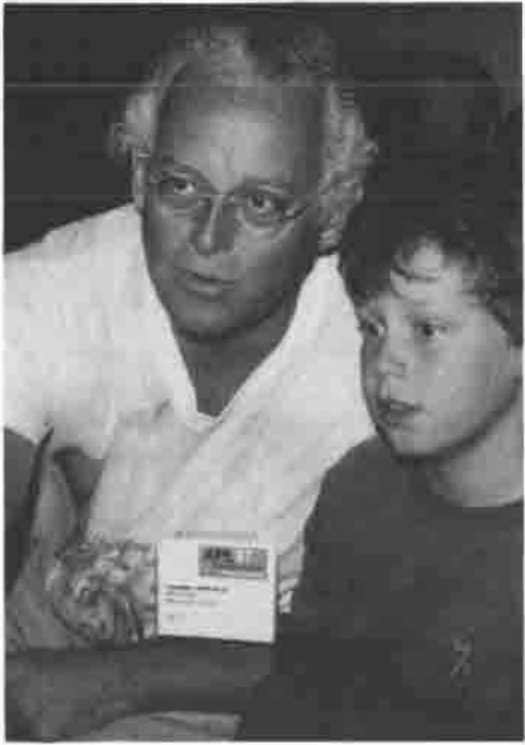 Chris Lincoln and his son looking at a screen
