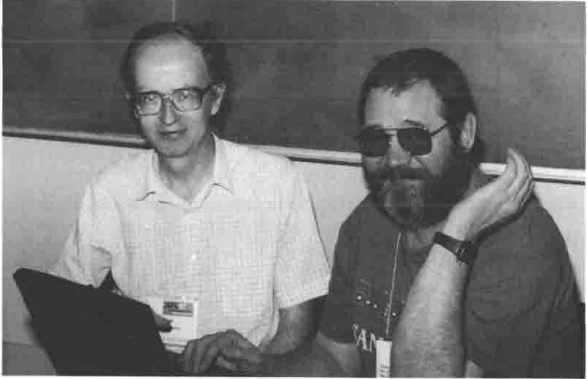 Adrian Smith at a laptop beside Sasha Skomorokhov