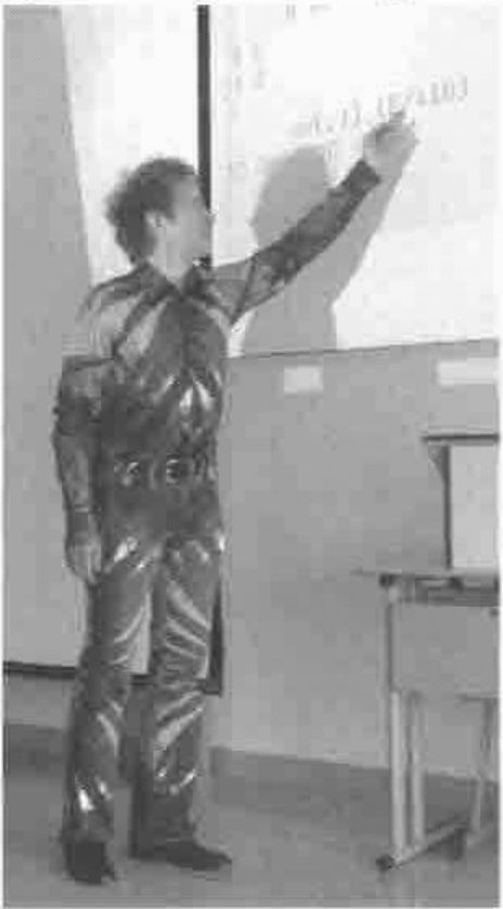 Peter-Michael Hager presenting, in a patterned suit