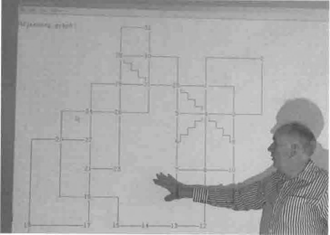 John Scholes pointing at a projected graph of the sea areas
