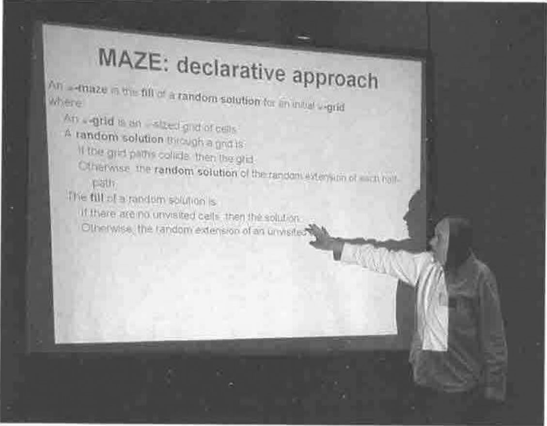 John Scholes pointing at a slide headed MAZE: declarative approach