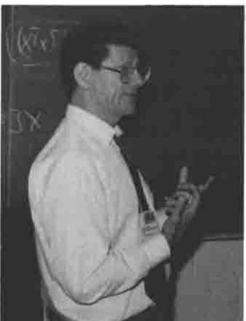 Alan Sykes at a blackboard