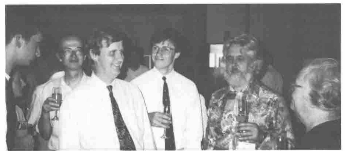 Six people with wine glasses, laughing