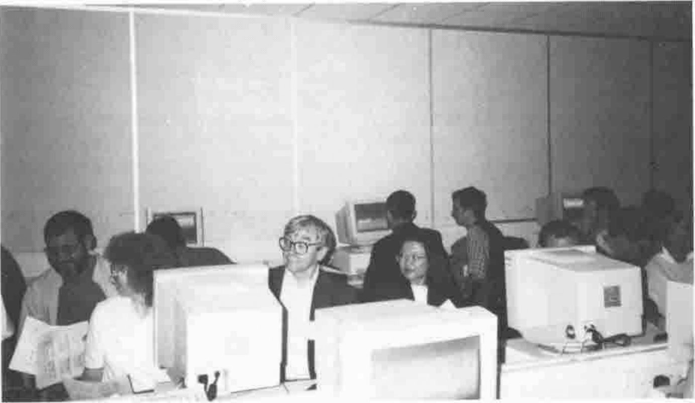 Photograph of delegates seated two to a PC in a computer lab