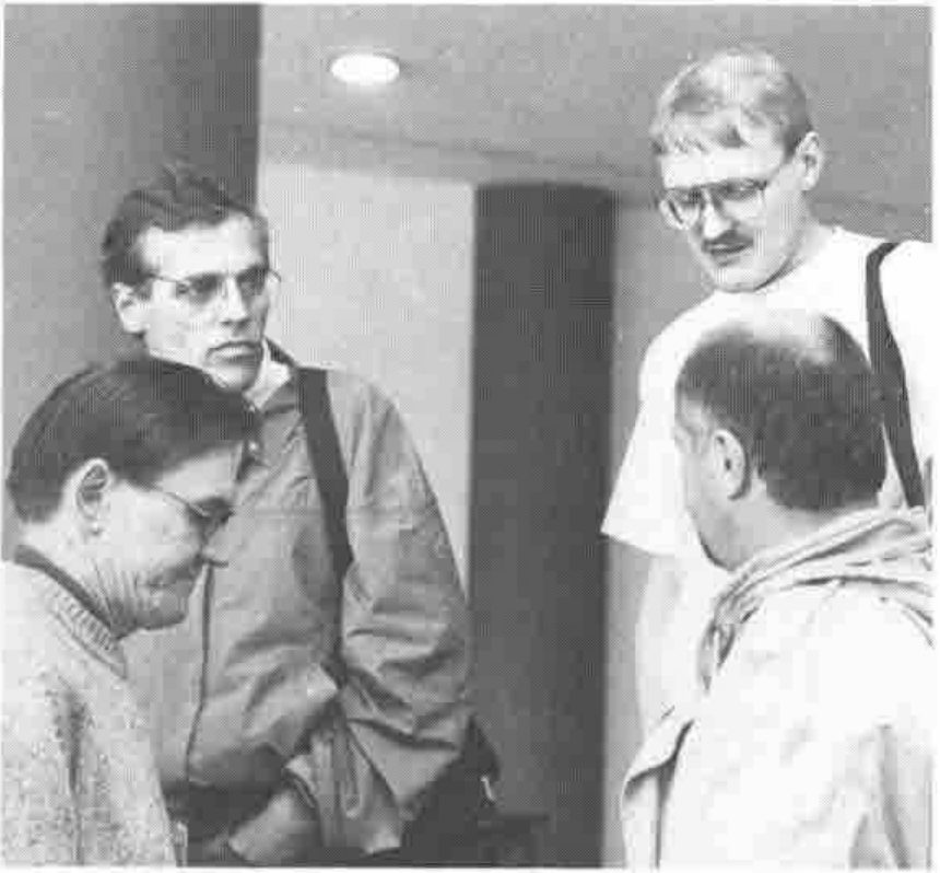 Photograph of four delegates in conversation