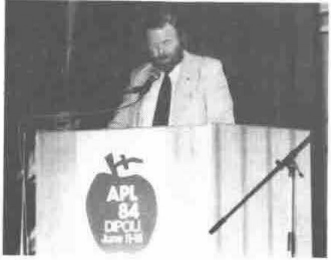 Phil Goacher, the chairman of the British APL Association, tells an expectant audience that APL86 will be held in Cambridge, England,