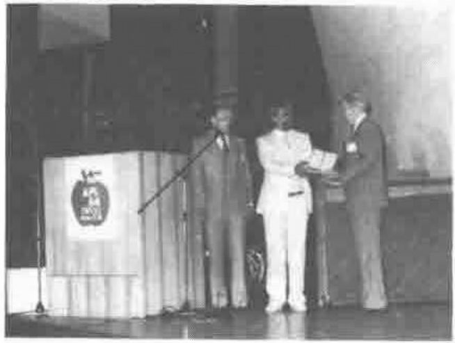 Eugene MacDonnell collects his award from APL84 conference chairman Timo Seppala.