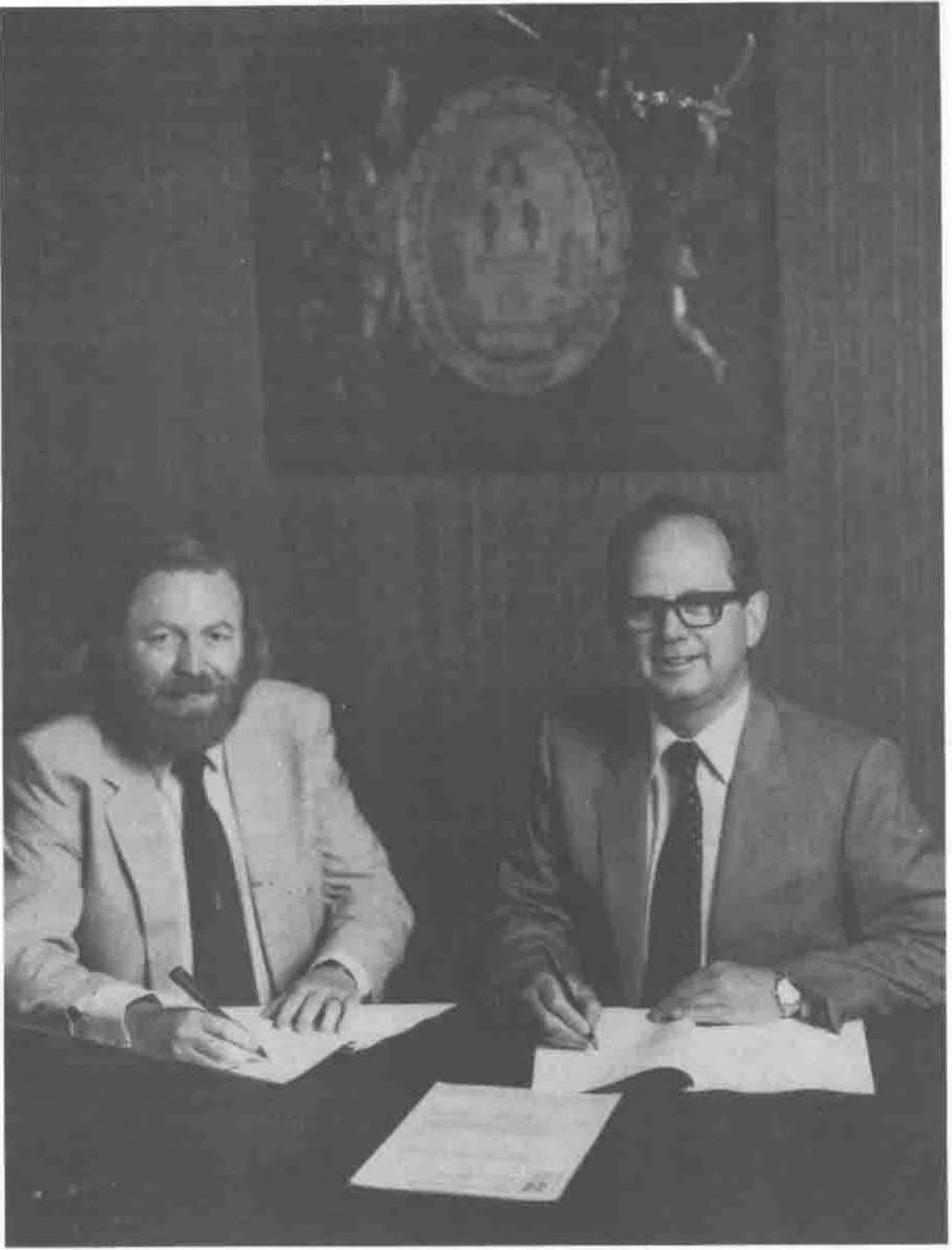 Philip Goader, BCS Business Manager (left) and Michael Black, University Publisher of CUP, signing the publishing contract.