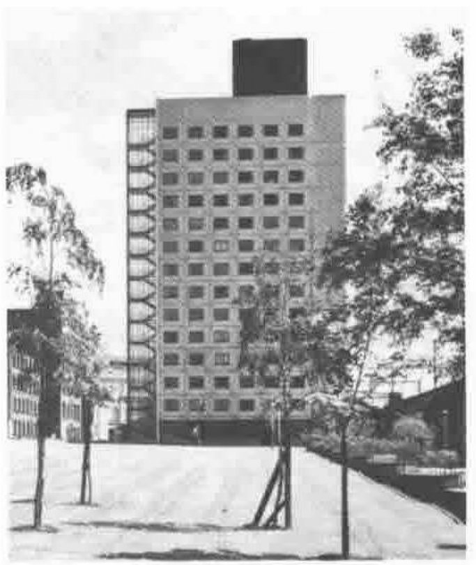Photograph of a UMIST hall of residence: a tower block behind young trees