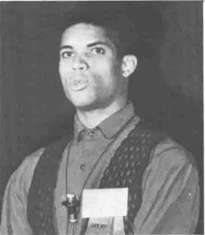 Photograph of Stanley Jordan speaking at a microphone