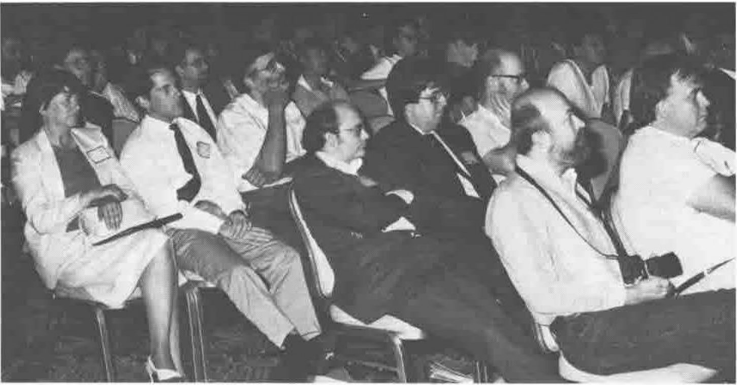 Photograph of rows of the conference audience, seated and attentive