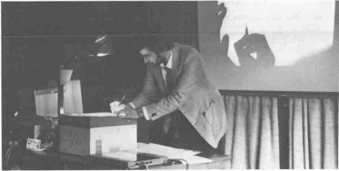 Photograph of Martyn Adams writing at an overhead projector