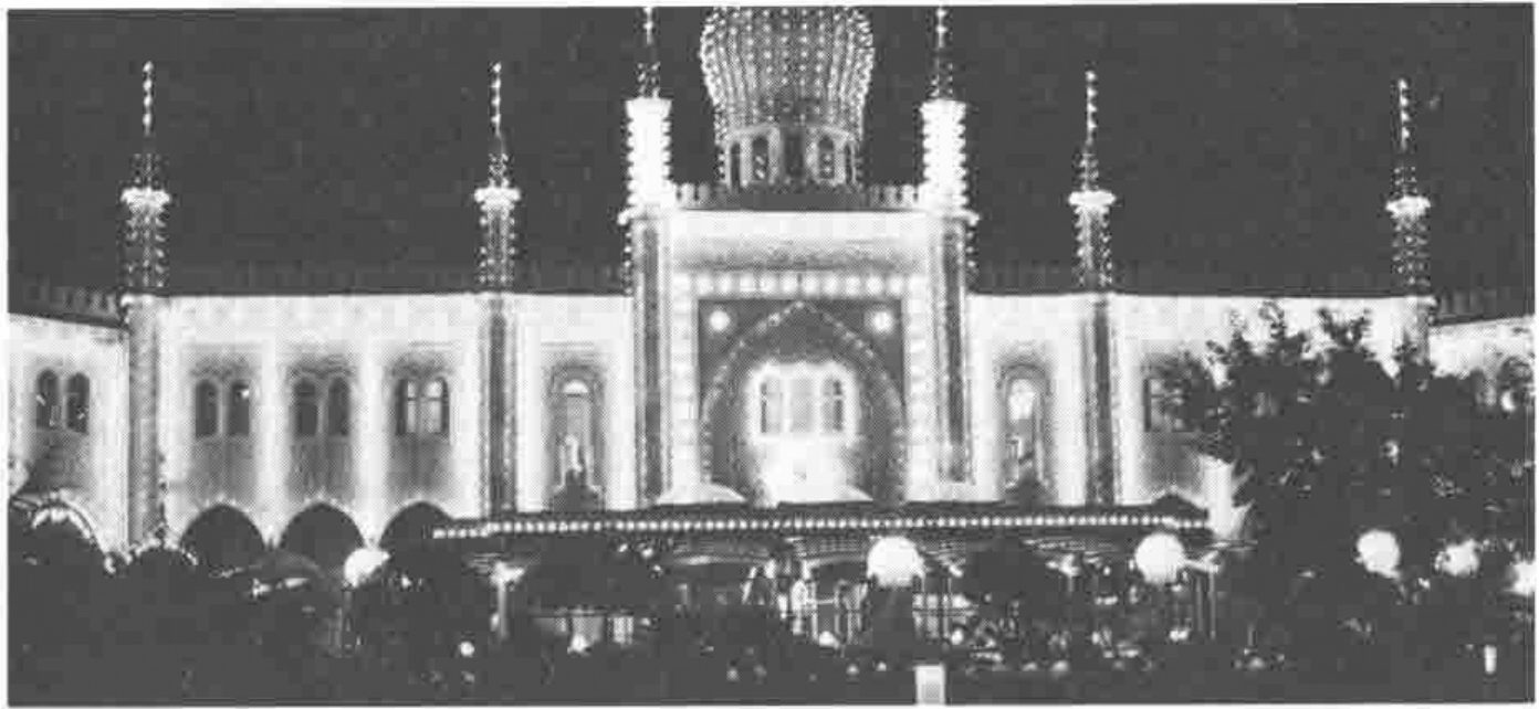 The illuminated façade of a domed, oriental-style restaurant at night