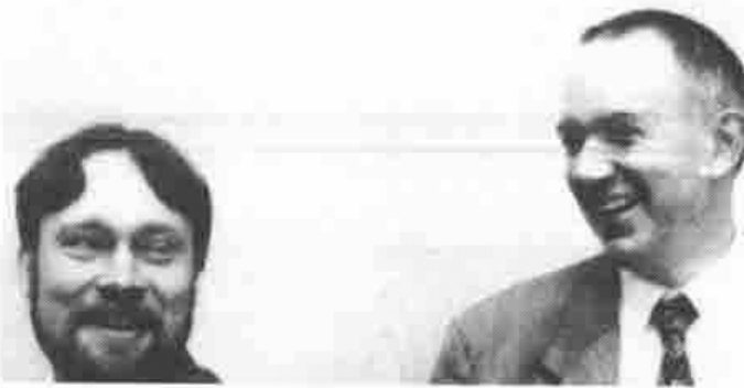 Two men, one bearded and smiling, the other laughing